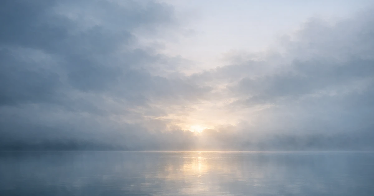 Abstract peaceful landscape with misty clouds reflected in calm water under soft morning light