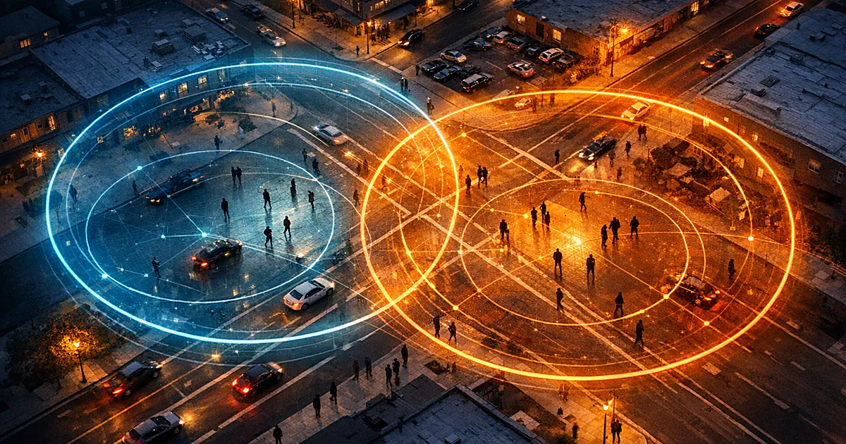 Aerial view of city intersection with glowing circular surveillance zones overlaying streets and small silhouettes below